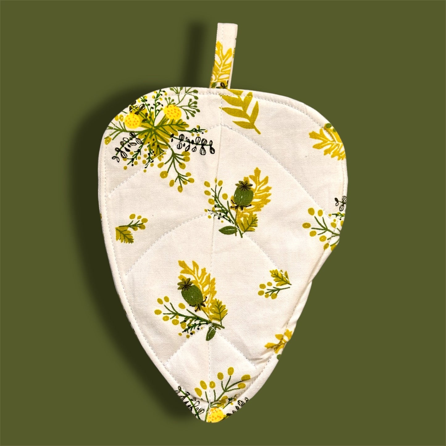 Quilted fabric leaf coaster.
