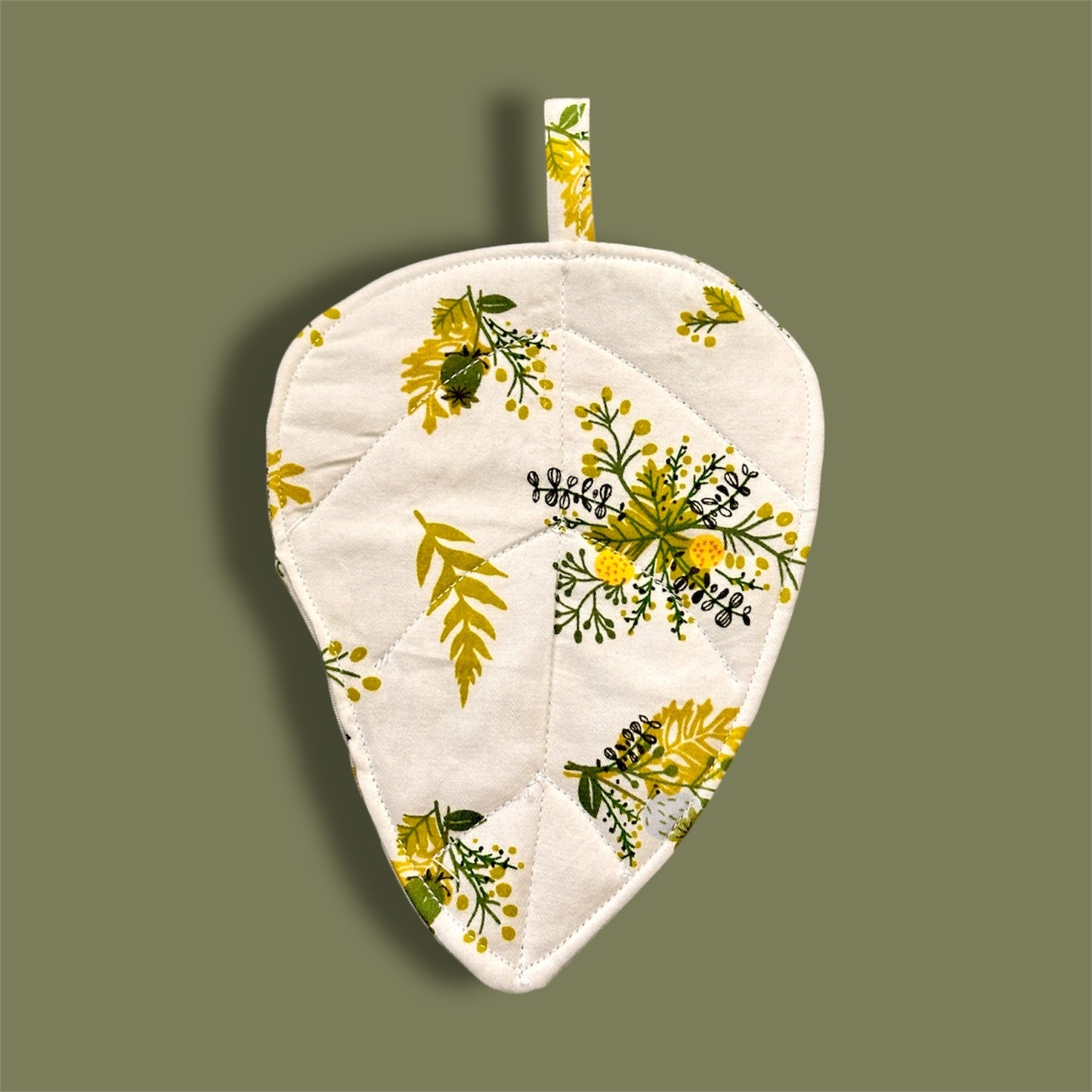 Quilted fabric leaf coaster.