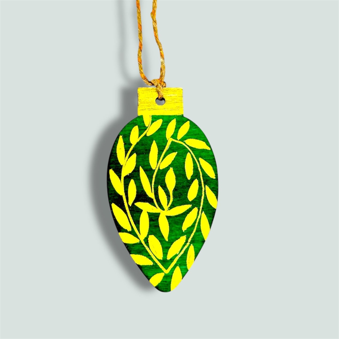 Green and gold wooden Christmas tree decoration.