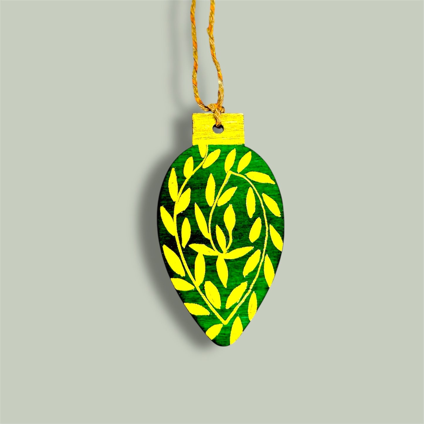 Green and gold wooden Christmas tree decoration.