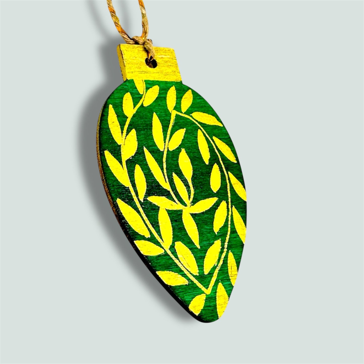 Green and gold wooden Christmas tree decoration.