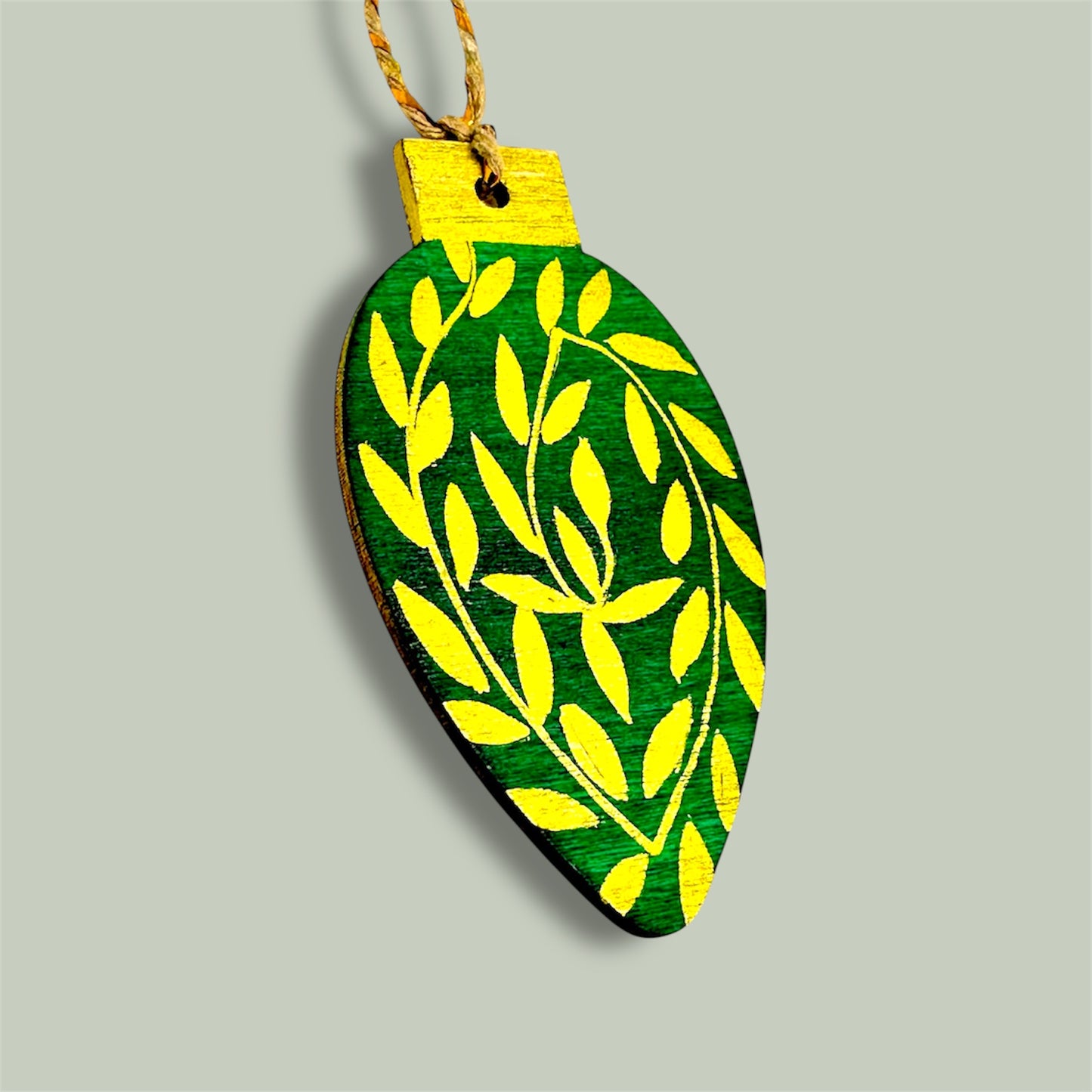 Green and gold wooden Christmas tree decoration.