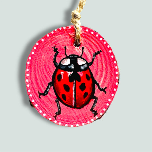 Handmade ladybird wood slice art.
